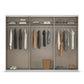 Rauch Wardrobe W271cm Interior, A modern three-compartment sliding wardrobe with frame and beige interior walls, shown open and styled with folded and hanging clothes, shoes, and a basket on a white background.