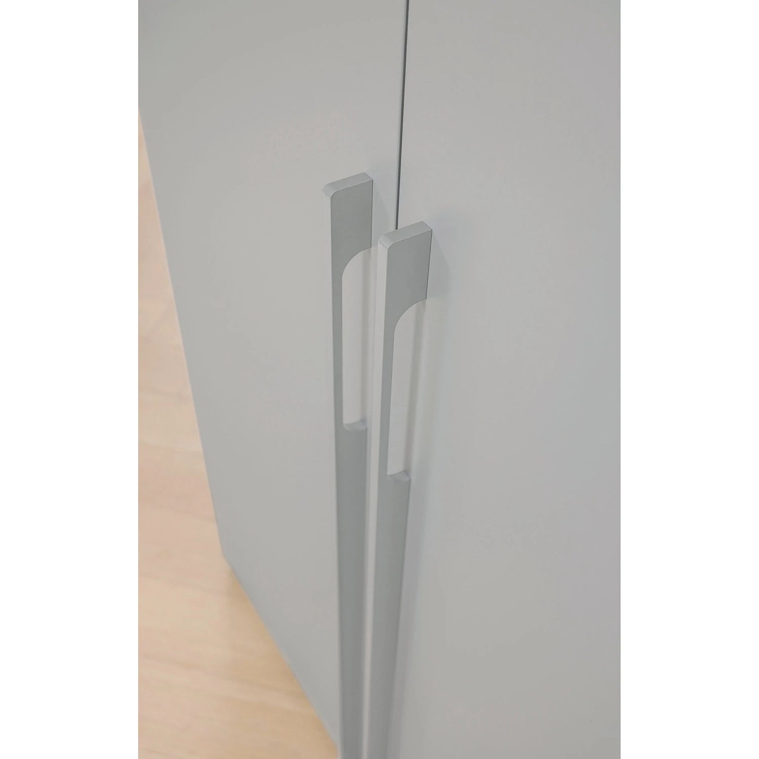 Close up of long door handles of Rauch Kacey 151cm 3 door wardrobe with dark grey glass centre door