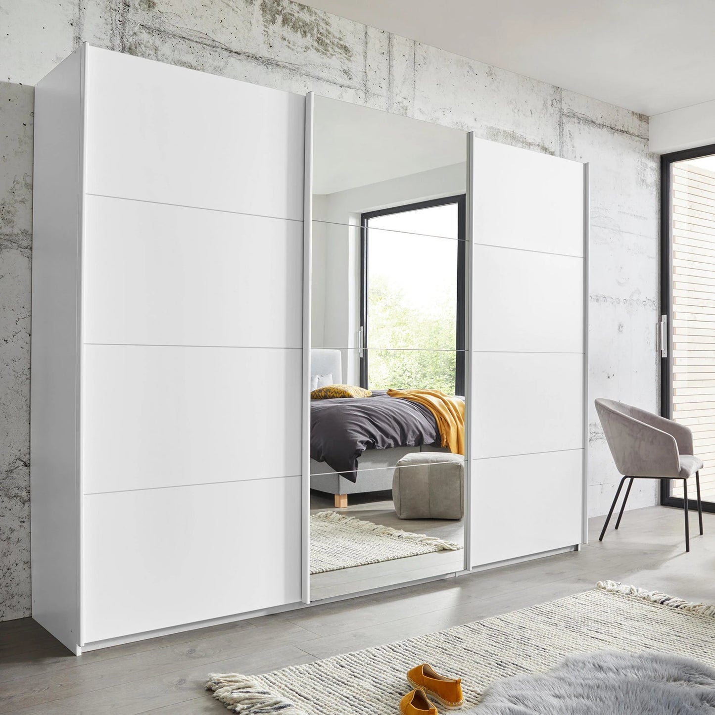 Rauch Forms three door sliding wardrobe in matt white décor with a mirrored centre door
