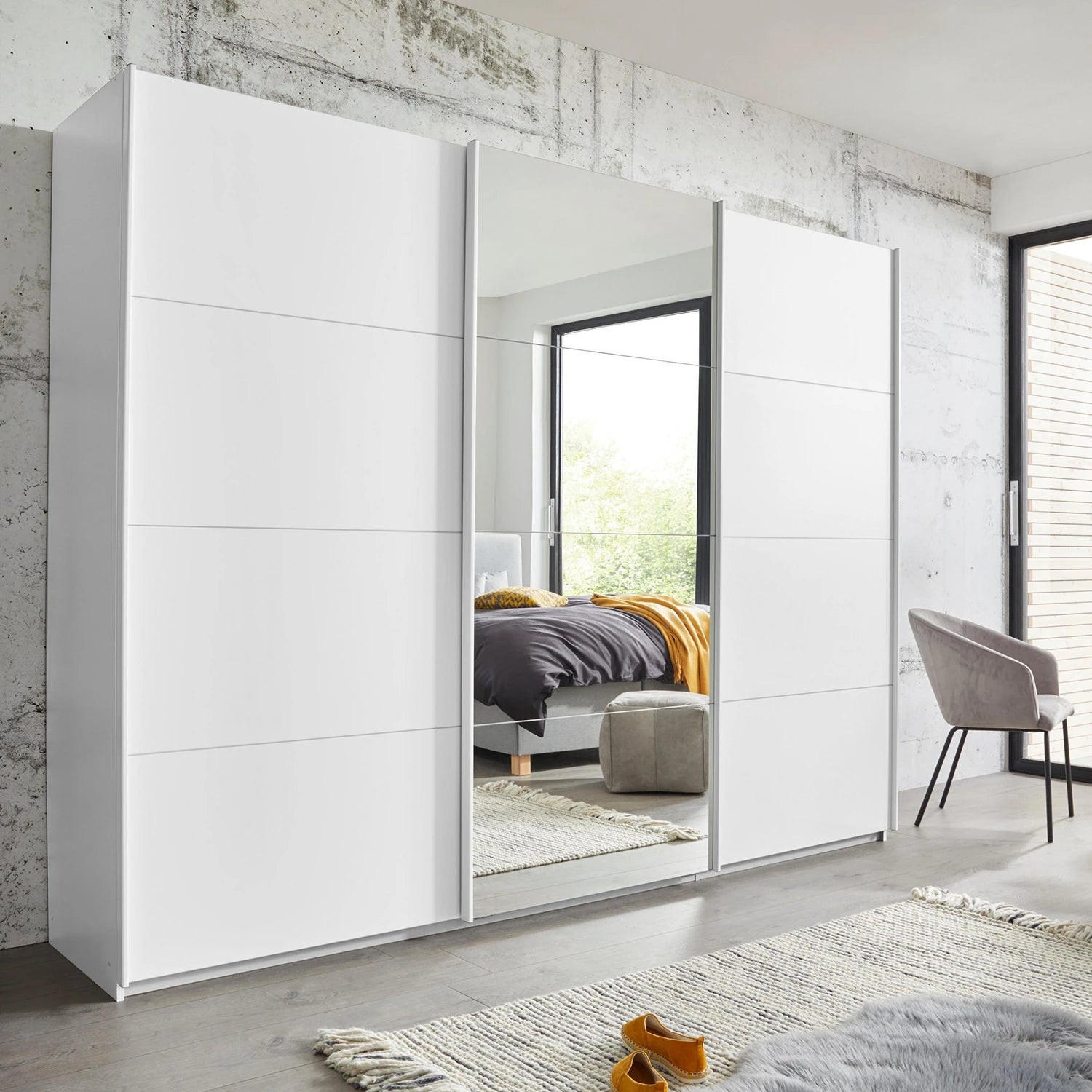Rauch Forms three door sliding wardrobe in matt white décor with a mirrored centre door
