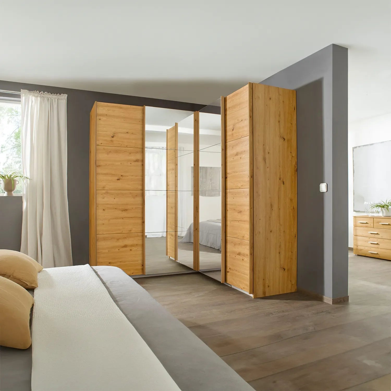 Rauch Lema 4 Door Sliding Corner Wardrobe - Artisan Oak - Styled in a Bedroom