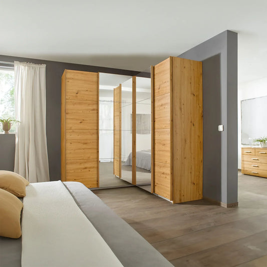 Rauch Lema 4 Door Sliding Corner Wardrobe - Artisan Oak - Styled in a Bedroom