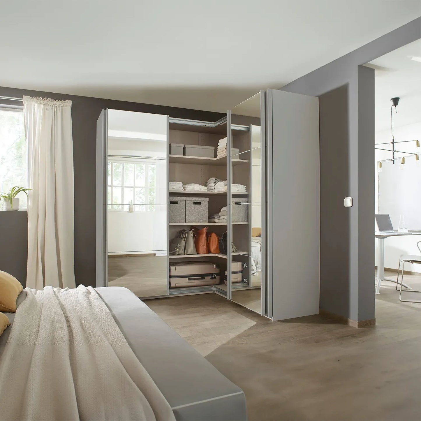 Rauch Lema 4 Door Sliding Corner Wardrobe - Silk Grey Glass - Styled in a Bedroom