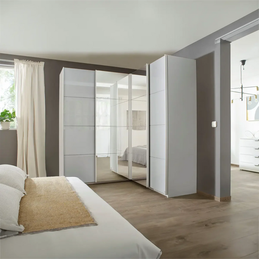 Rauch Lema 4 Door Sliding Corner Wardrobe - Silk Grey Glass - Styled in a Bedroom