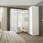 Rauch Lema 4 Door Sliding Corner Wardrobe - White High Gloss - Styled in a Bedroom