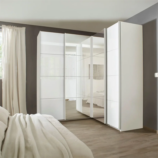 Rauch Lema 4 Door Sliding Corner Wardrobe - White High Gloss - Styled in a Bedroom