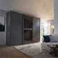 Modern interior with a large grey Lumia wardrobe with 3 sliding doors