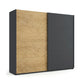 A modern sliding wardrobe with two doors: one in a light oak wood grain finish and the other in a matte dark charcoal gray finish from Rauch Orange Malva Range