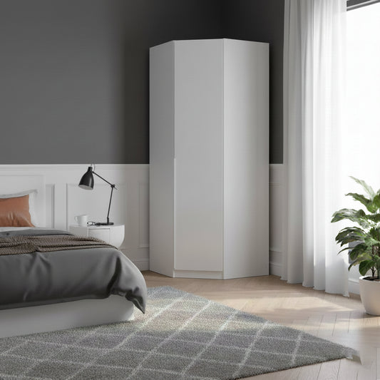 A tall white corner wardrobe in a modern bedroom setting with a gray wall, white wainscoting, a bed, a side table with a black lamp, sheer white curtains, and a potted green plant.