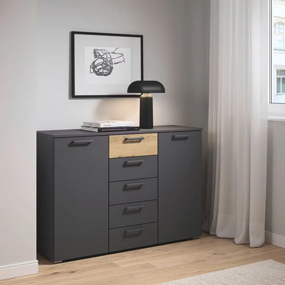 Rauch Miro 2 Door 5 Drawers Bedside Table in Metallic Grey & Artisan Oak styled in a modern bedroom