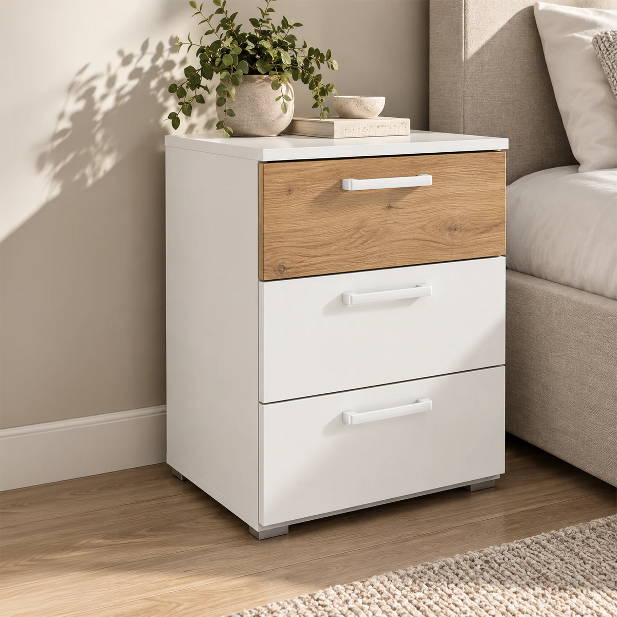 Rauch Miro 3 Drawer Bedside Table in Alpine White & Artisan Oak styled in a modern bedroom