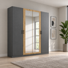 Rauch Miro 4 Door Hinged Wardrobe With Mirror in Metallic Grey styled in a modern bedroom