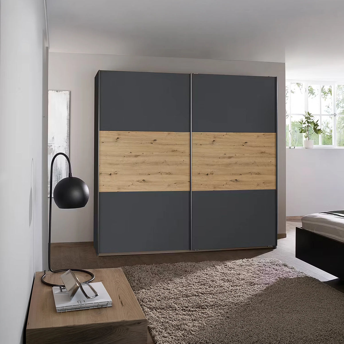 Rauch Miro 2 Door Sliding Wardrobe in Metallic Grey & Artisan Oak styled in a modern bedroom