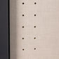 Close-up of a textured beige surface with small holes arranged in a vertical pattern in wardrobe