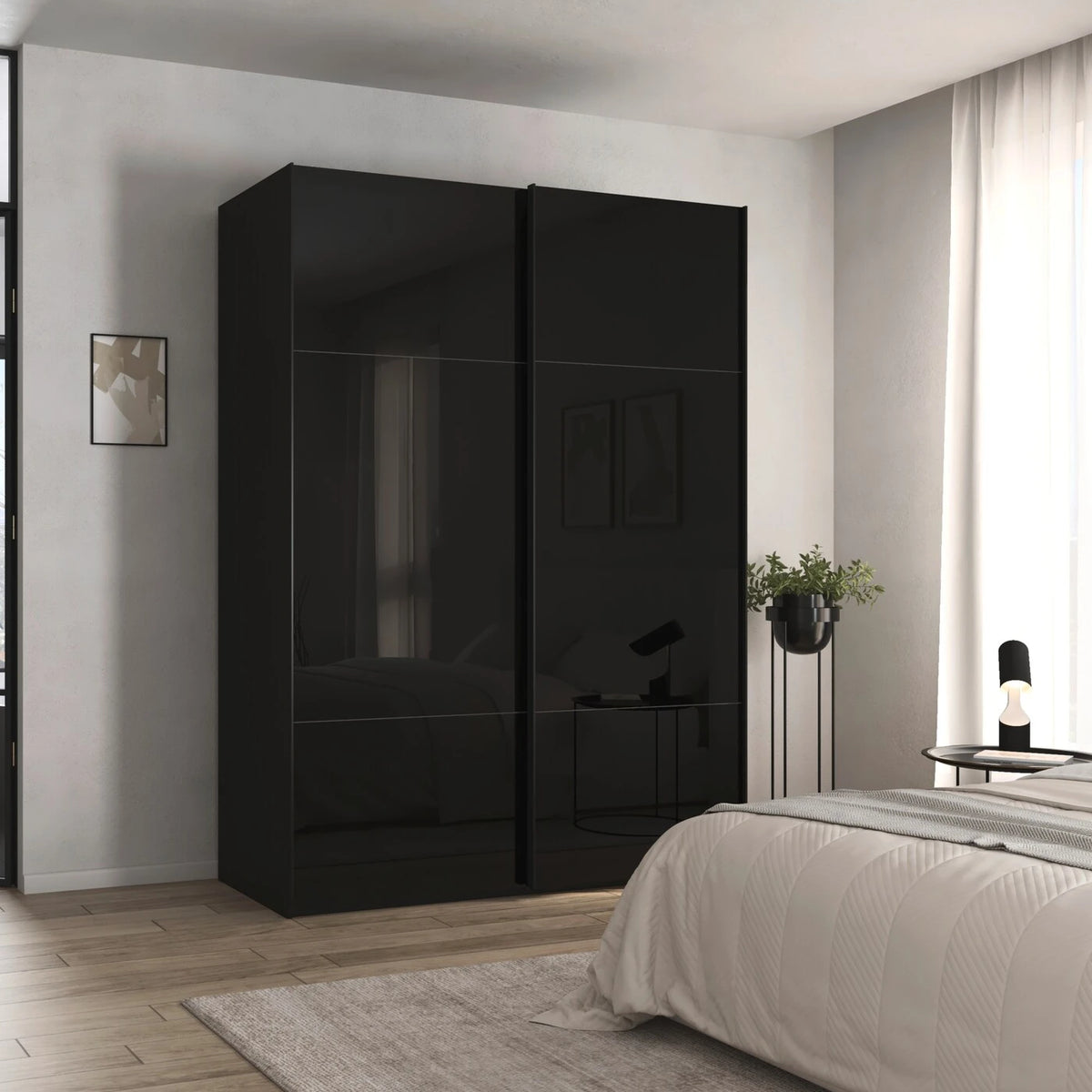 A tall black high-gloss wardrobe Rauch Orange Plus Contido with two sliding doors in a modern bedroom setting next to a bed with white bedding.