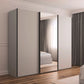 A modern sliding wardrobe with light gray doors and black handles, set in a bedroom with wood floors, curtains, and a bed visible in the mirror reflection.