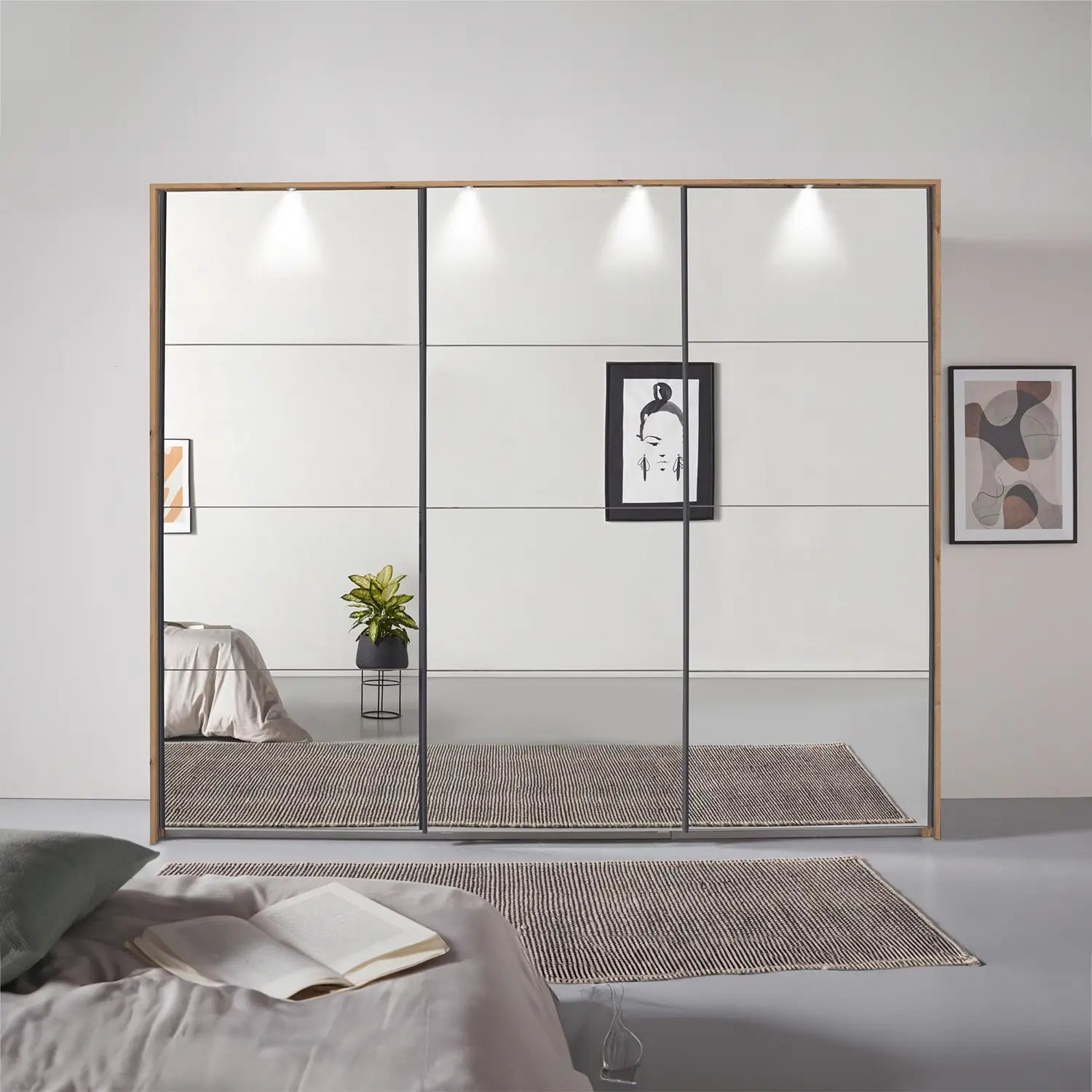 Rauch Prism Artisan Oak 3 Door Full Mirror Sliding Wardrobe - 271cm - Passepartout Frame with Light - Styled in a Bedroom