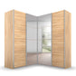 A modern Rauch Quadra Lema corner wardrobe with light oak wood grain doors and mirrored sliding panels, shown on a clean white background.