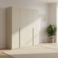 Rauch Heaven 201cm 4 Door Hinged Wardrobe with Décor Doors in Champagne styled in a modern room