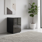 Rauch Heaven 3 Drawer Bedside Cabinet with Glass Top and Front in Black styled in a modern room