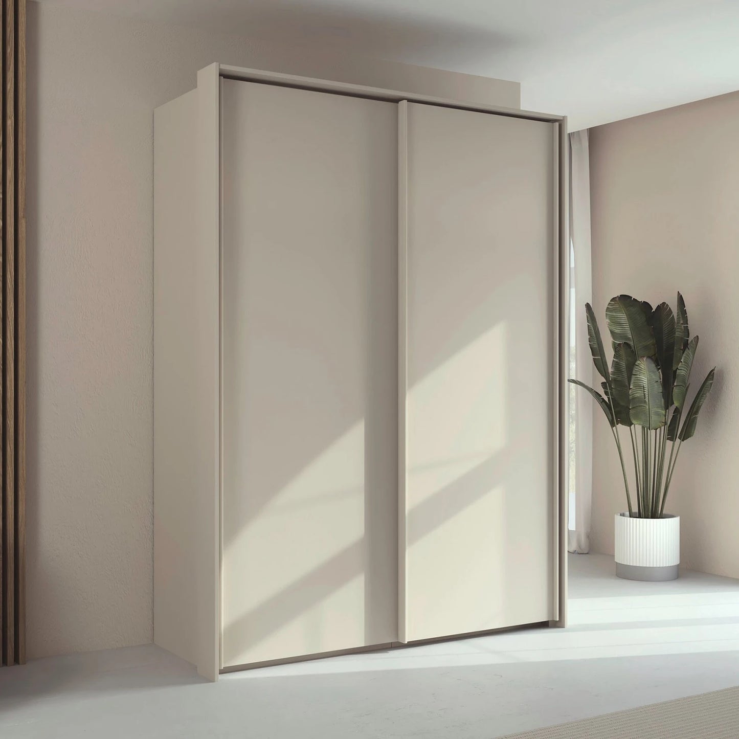 Rauch Taro 2 Door Sliding Wardrobe in Champagne finish with passepartout frame styled in a modern room