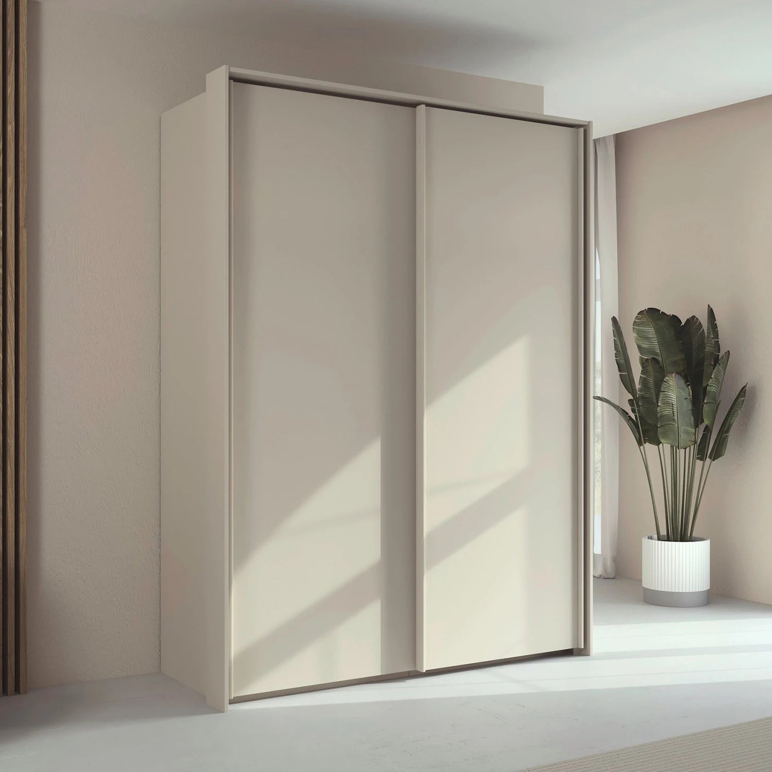 Rauch Taro 2 Door Sliding Wardrobe in Champagne finish with passepartout frame styled in a modern room