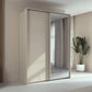 Rauch Taro 2 Door 1 Mirror Door Sliding Wardrobe in Champagne finish with passepartout frame styled in a modern bedroom