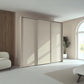 Rauch Taro 3 Door Sliding Wardrobe in Champagne finish with passepartout frame styled in a modern room
