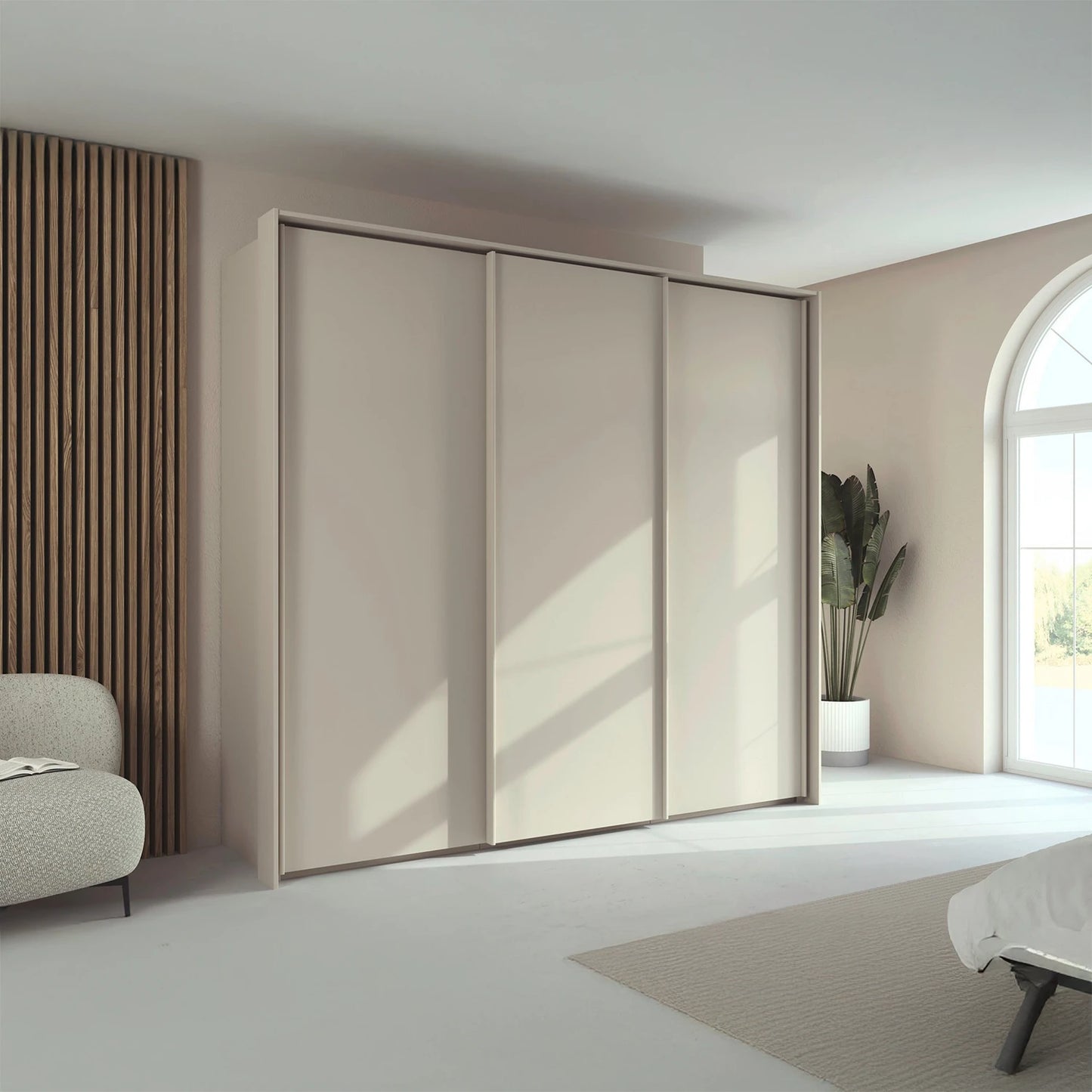Rauch Taro 3 Door Sliding Wardrobe in Champagne finish with passepartout frame styled in a modern room