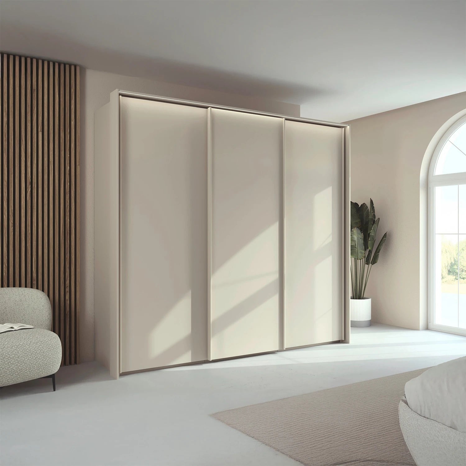 Rauch Taro 3 Door Sliding Wardrobe in Champagne finish with passepartout light frame styled in a modern room