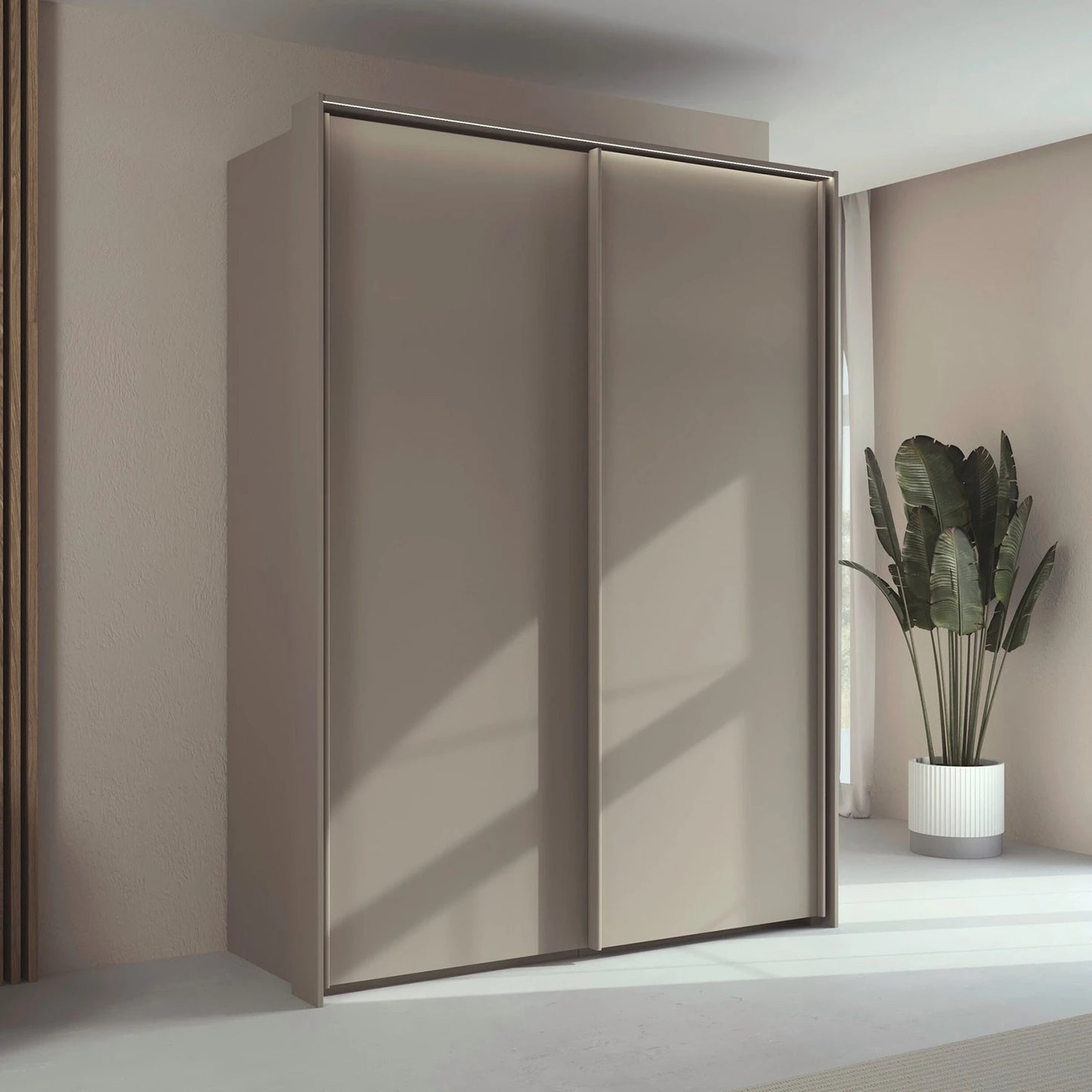 Rauch Taro 2 Door Sliding Wardrobe in Champagne finish with passepartout frame with light styled in a room