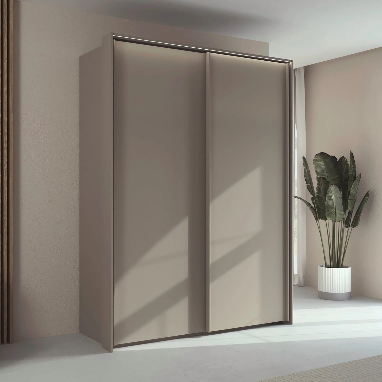 Rauch Taro 2 Door Sliding Wardrobe in Champagne finish with passepartout frame with light styled in a room