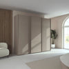 Rauch Taro 3 Door Sliding Wardrobe in Fango finish styled in a modern bedroom