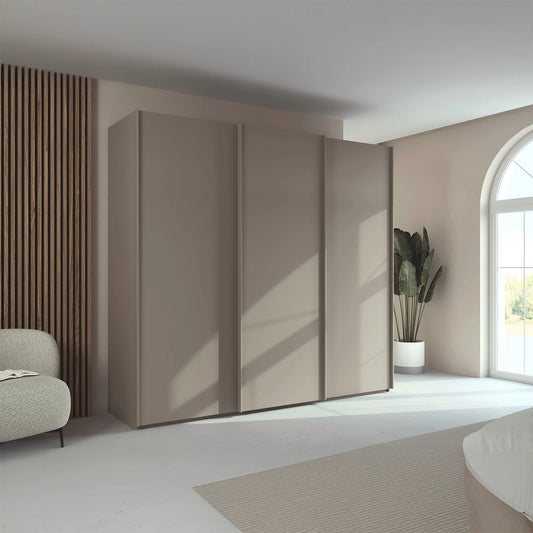 Rauch Taro 3 Door Sliding Wardrobe in Fango finish styled in a modern bedroom