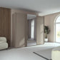 Rauch Tara 3 Door Sliding Wardrobe in Fango with central mirror door styled in a modern bedroom