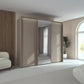 Rauch Taro 3 Door Sliding Wardrobe in Fango with central mirror door with passepartout light frame styled in a modern bedroom