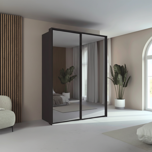 Rauch Taro 2 Door full mirror sliding wardrobe with Graphite Carcase double mirrored doors with passepartout frame styled in a modern bedroom