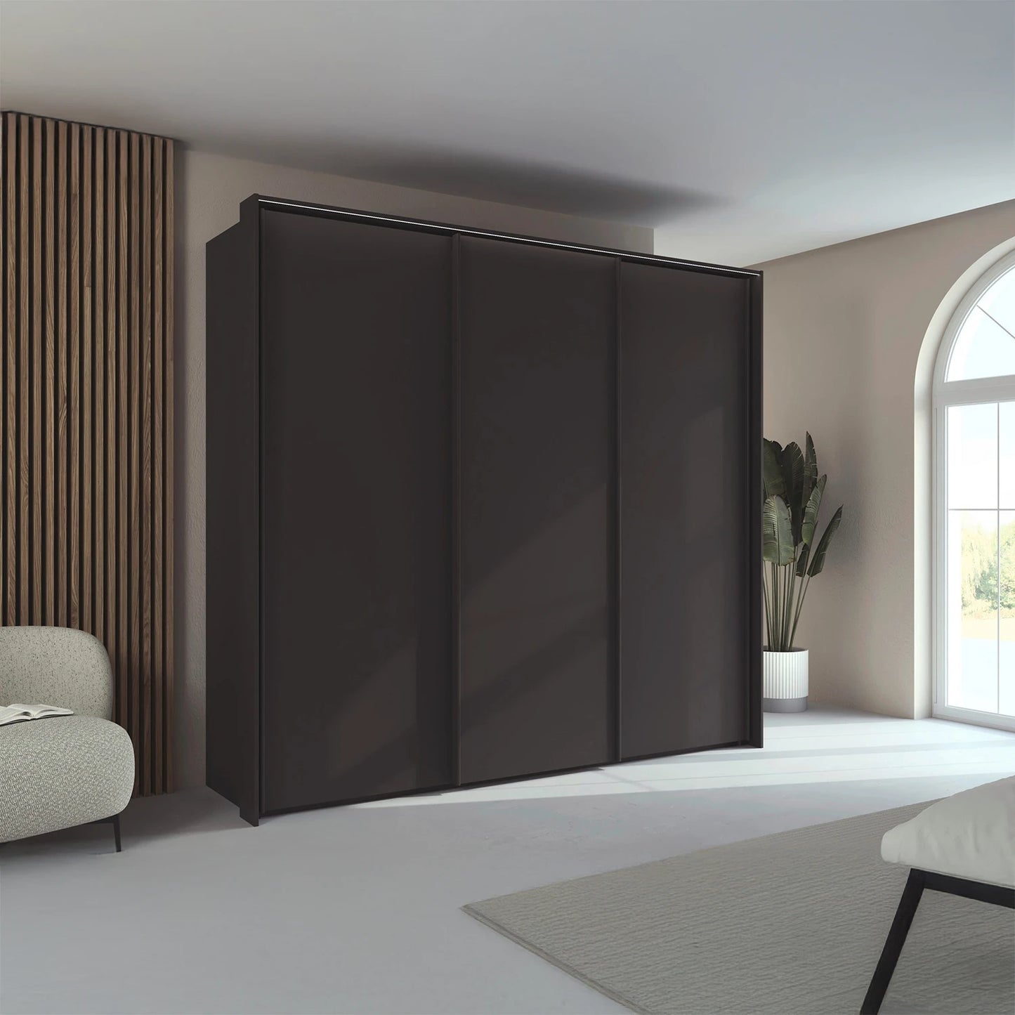 Rauch Taro 3 Door Sliding Wardrobe in Graphite finish styled in a modern bedroom