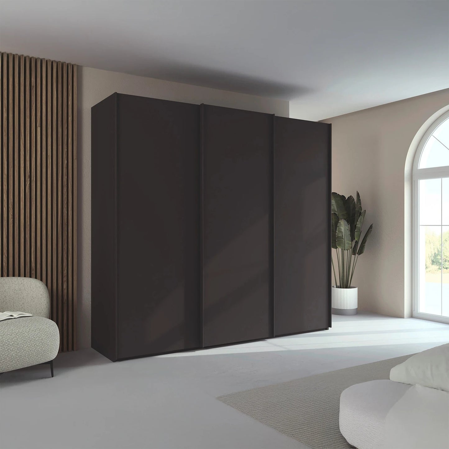 Rauch Taro 3 Door Sliding Wardrobe in Graphite finish styled in a modern bedroom