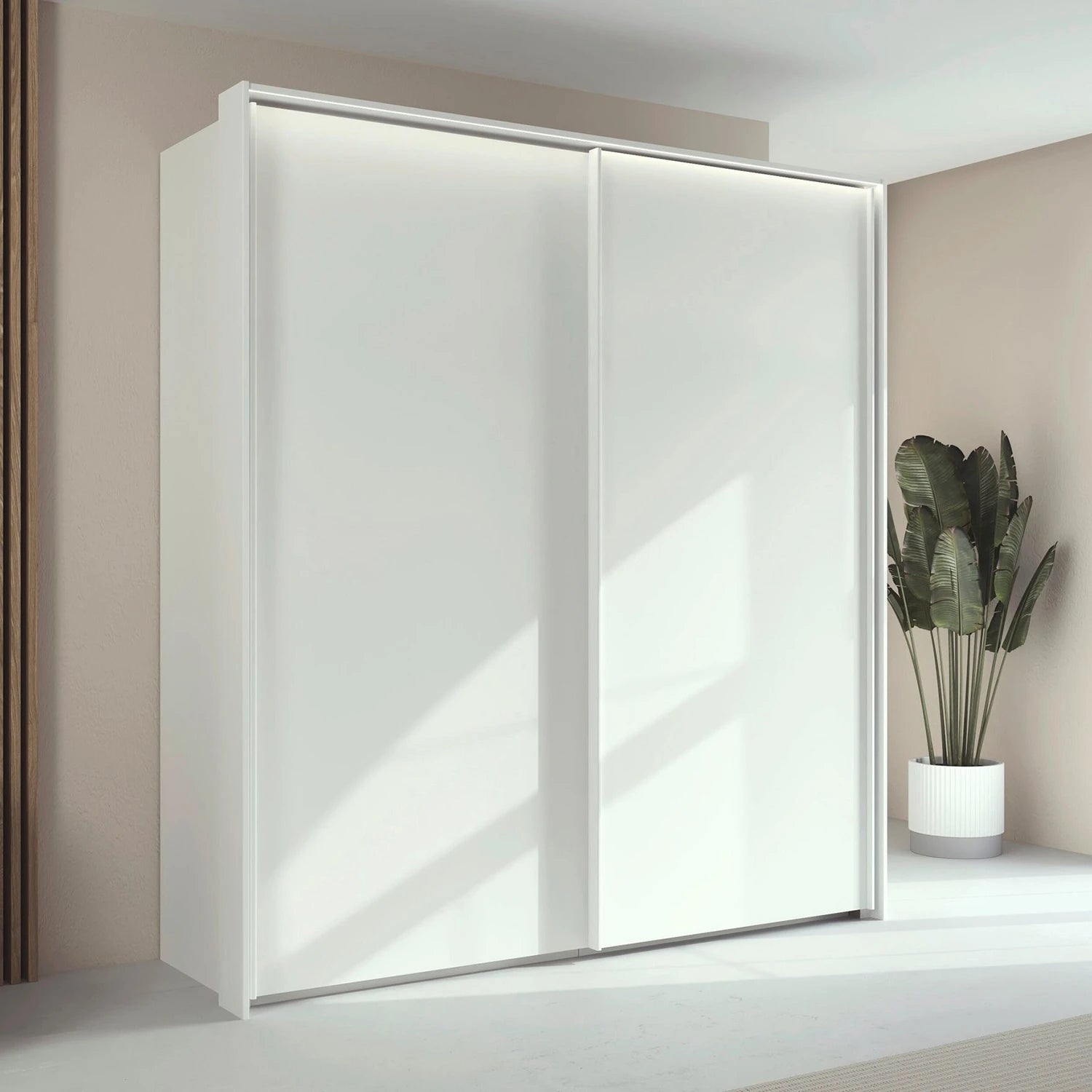 Rauch Taro 2 Door Sliding Wardrobe in Alpine White finish styled in a modern room 