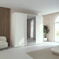 Rauch Tara 3 Door Sliding Wardrobe in Alpine White with central mirror door styled in a modern bedroom