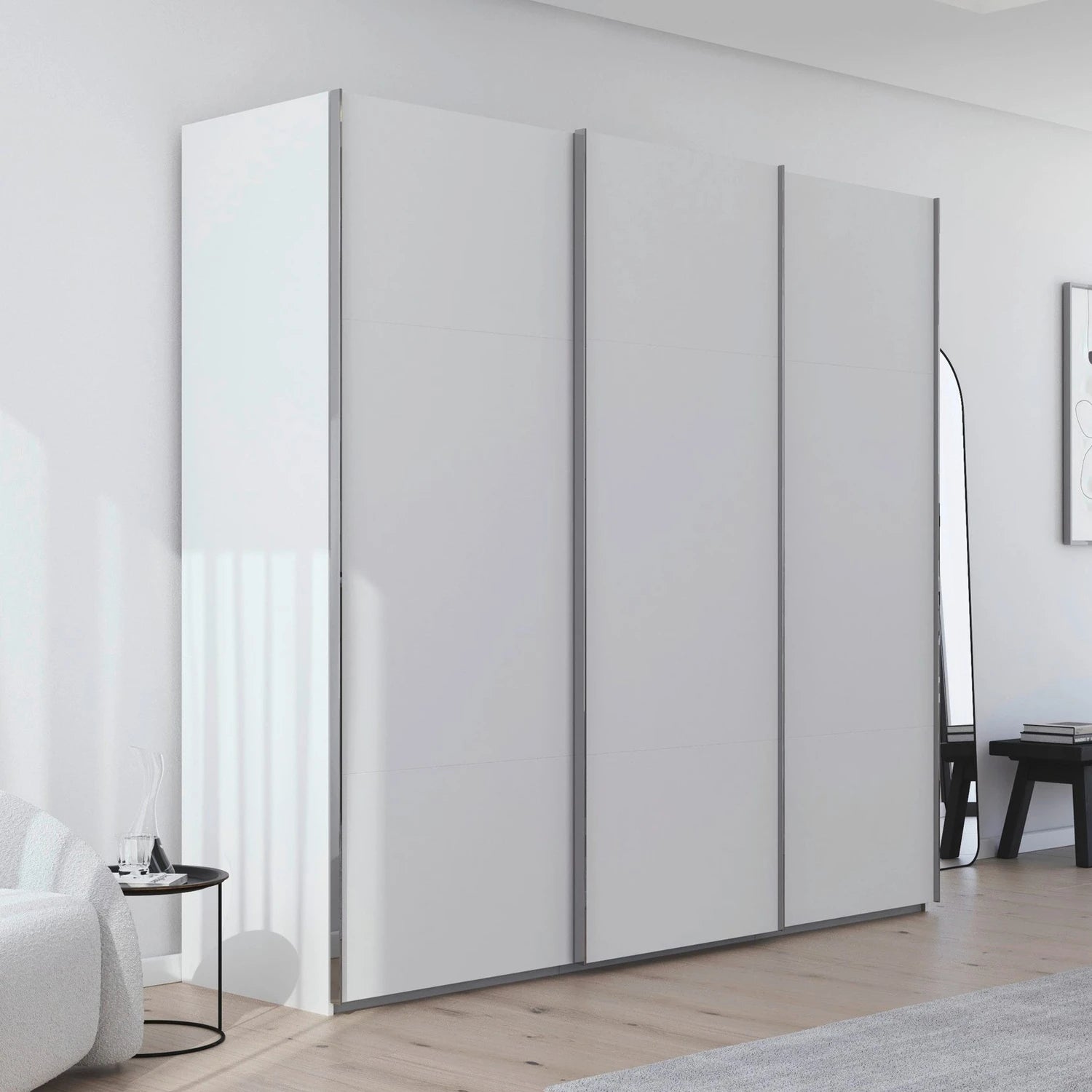 Rauch Contido 3 Door Sliding Wardrobe in White - Styled in a Bedroom