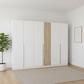 Rauch Lamela 6 door hinged wardrobe in Alpine white styled in a modern room