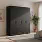 Rauch Heaven 200cm 4 Door Combi Wardrobe with Décor Doors in Black styled in a modern bedroom