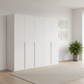 Rauch Heaven 251cm 5 Door Hinged Wardrobe with Décor Doors in White styled in a modern bedroom