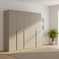 Rauch Heaven 251cm 5 Door Hinged Wardrobe with Décor Doors in fango styled in a modern bedroom