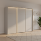 Rauch Heaven 270cm 3 Door Slider Wardrobe with Décor Doors and Lights in Silk Grey styled in a modern bedroom