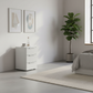 Rauch Heaven 3 Drawer Bedside Cabinet with Glass Top and Front in Silk Grey styled in a modern room