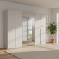 Rauch Heaven 300cm 6 Door Hinged Wardrobe with 4 Glass Doors and 2 Mirror Doors in Silk Grey styled in a modern bedroom