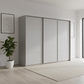 Rauch Heaven 300cm 3 Door Slider Wardrobe with Décor Doors in Silk Grey styled in a modern bedroom